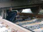 Funkcjonariusz Służby Celno-Skarbowej w czasie wyciągania papierosów spod wagonu pociągu