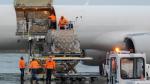 Pracownicy lotniska wyładowują towary z samolotu